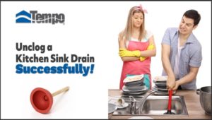 A woman using a plunger to unclog a kitchen sink.