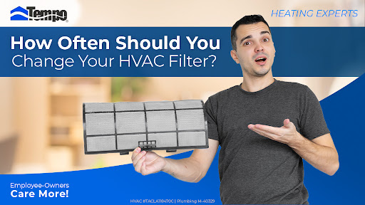 Man holding HVAC filter wondering when to change it
