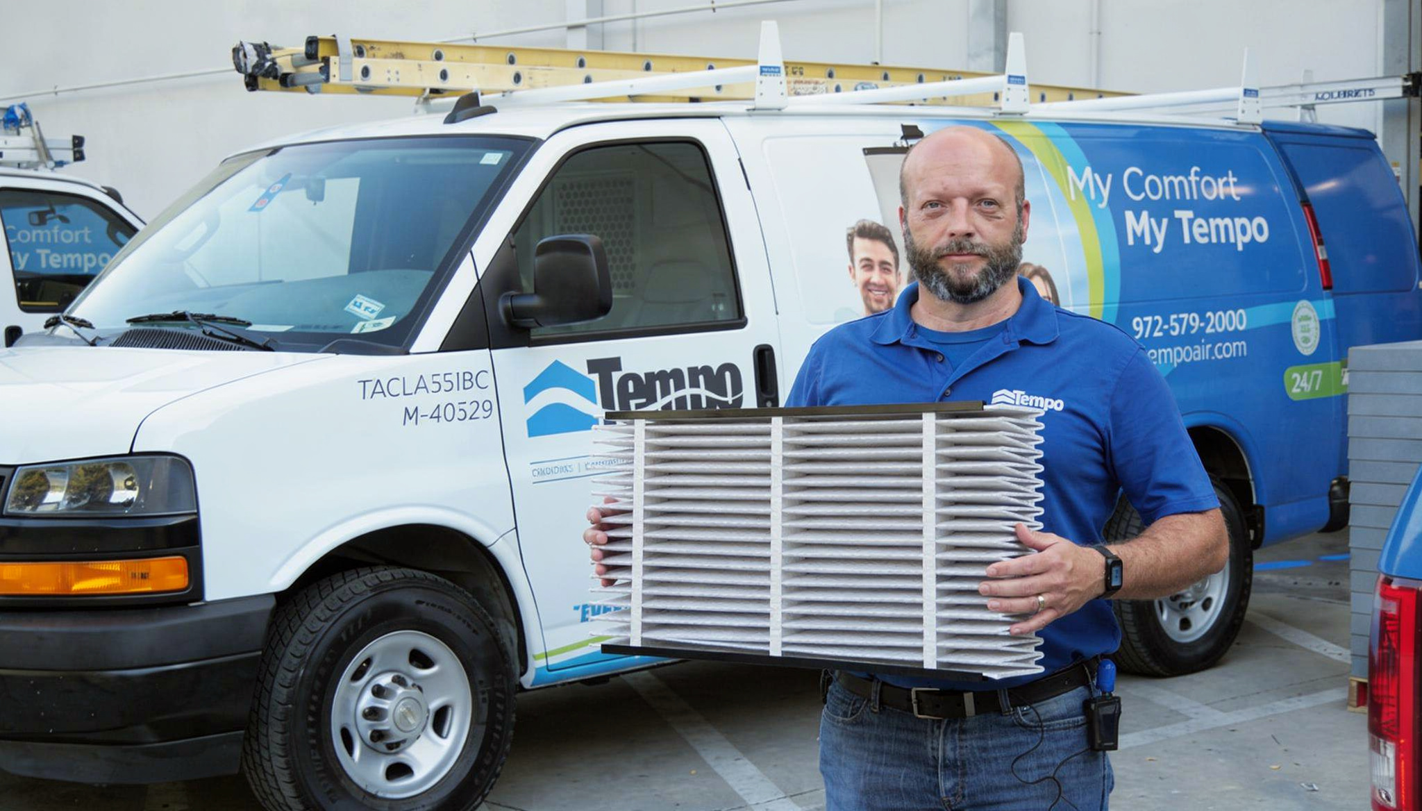 alt text="Image showing a Tempo Air technician holding a dirty air filter, highlighting the need for regular air filter replacement to maintain indoor air quality."