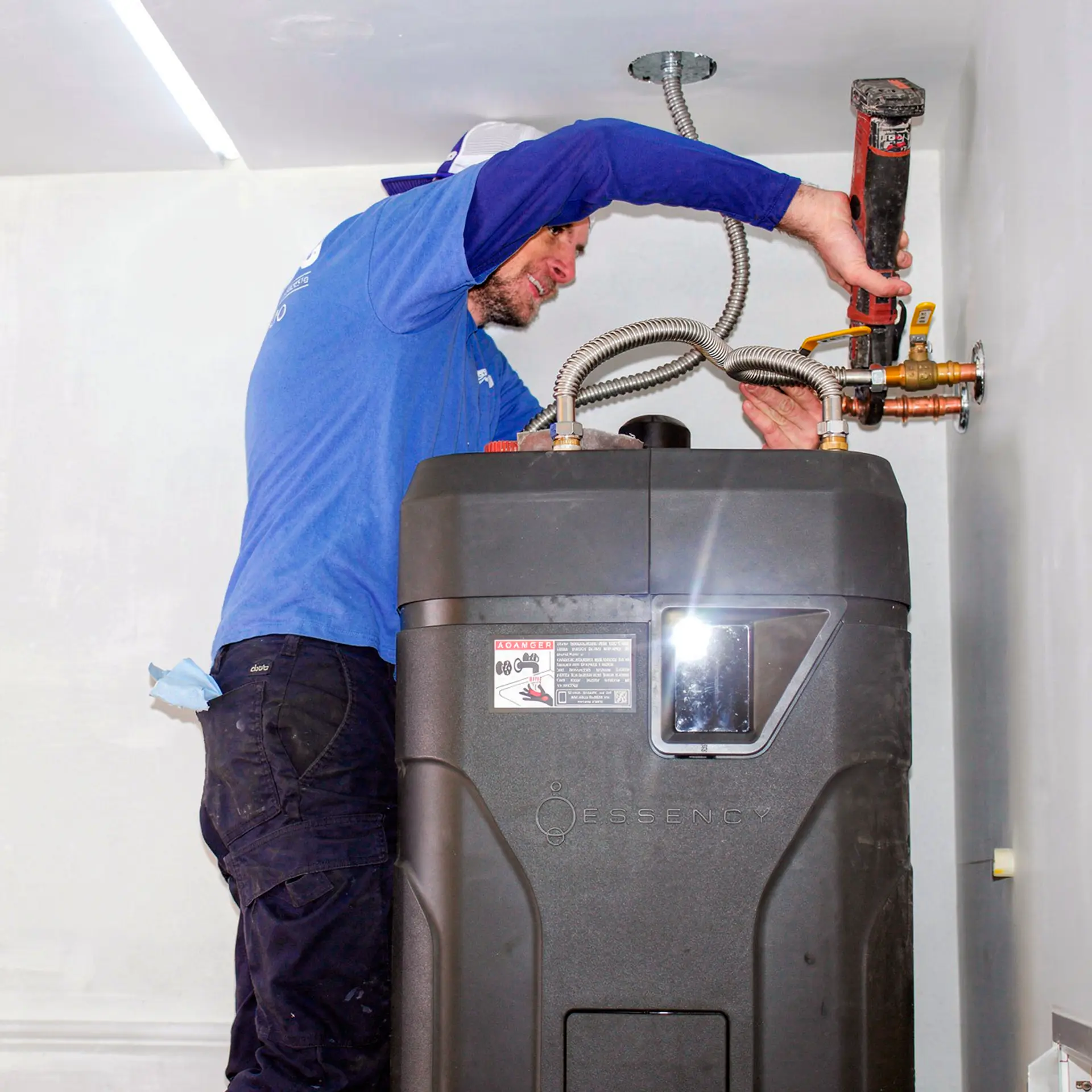 alt text="Square image of plumber performing water heater replacement service"
