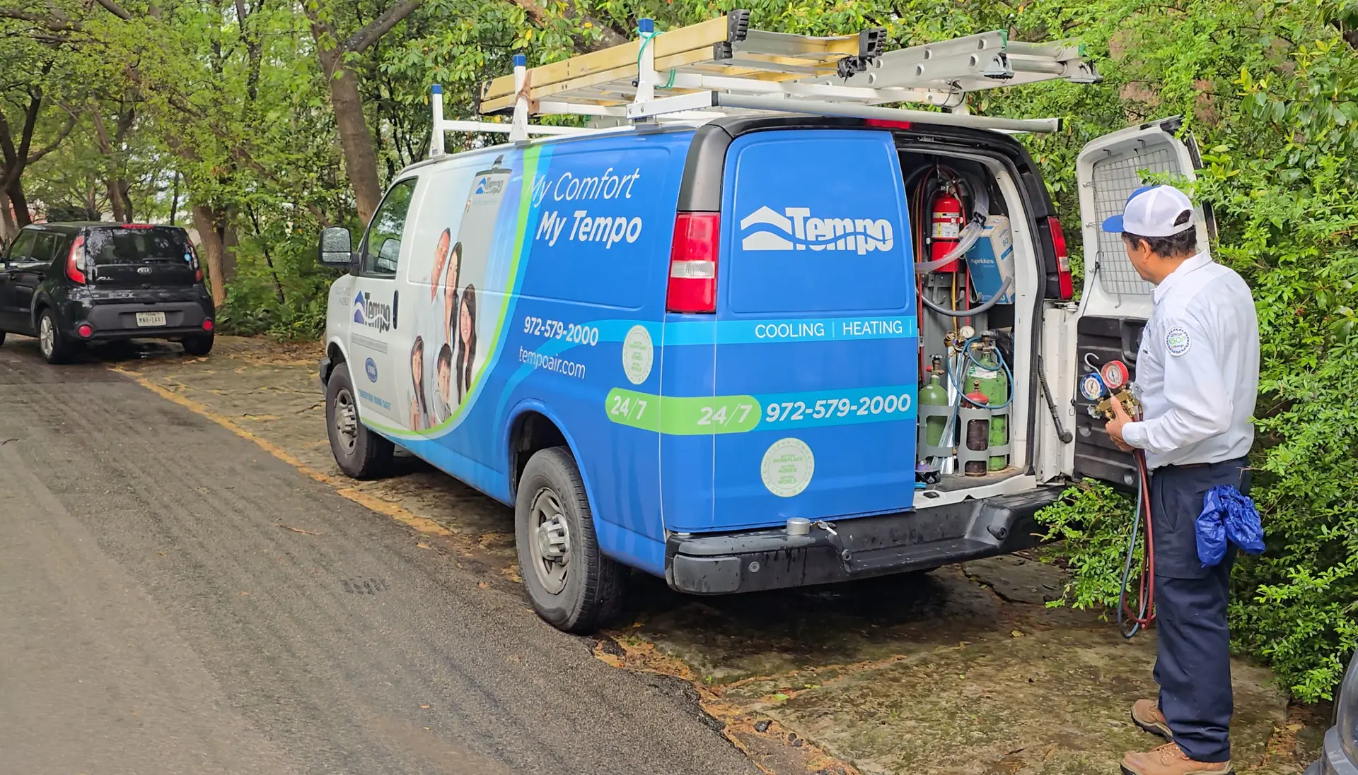 alt text="Professional HVAC technician troubleshooting cooling equipment during a residential service visit."