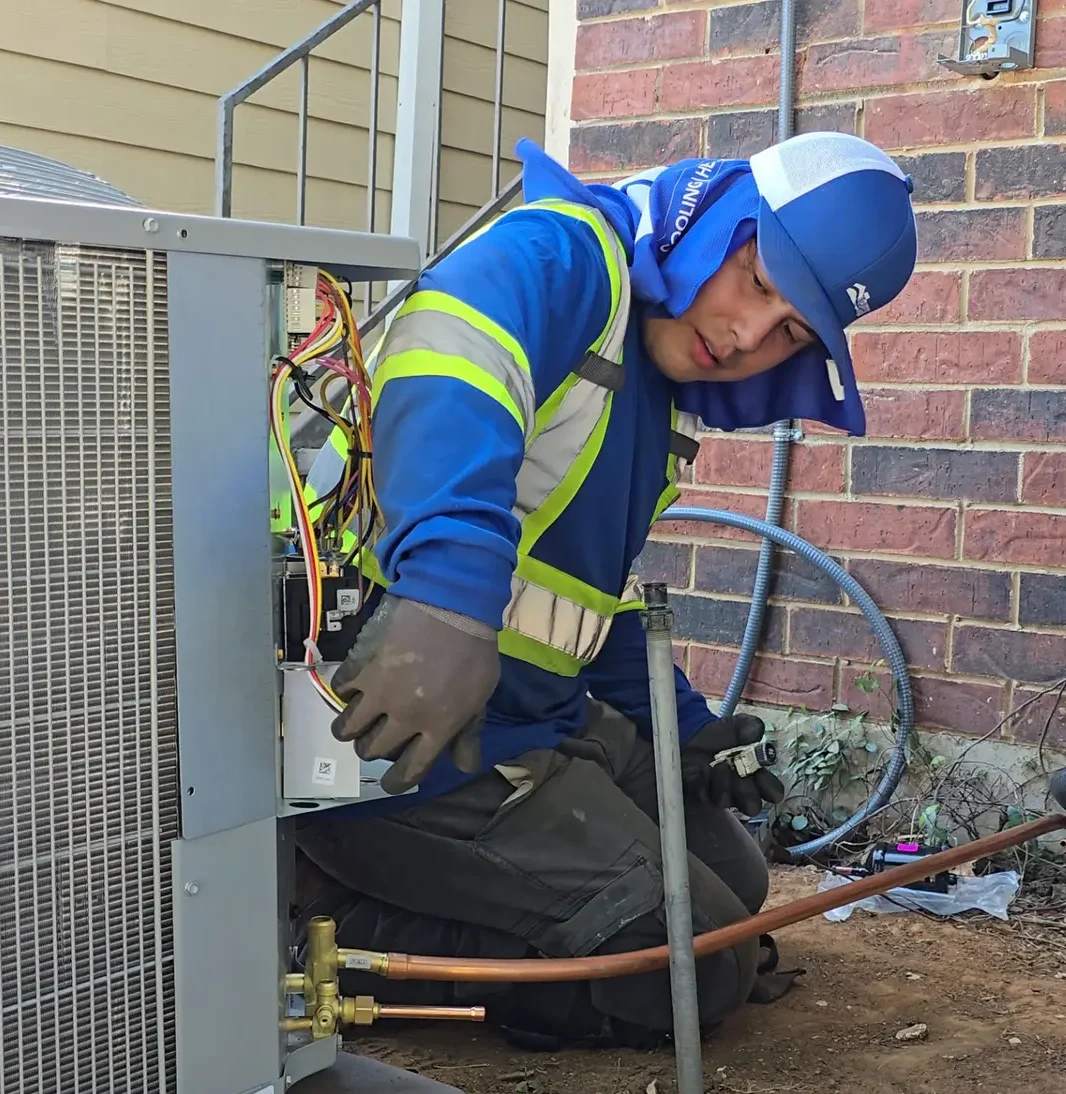 alt text="Tempo Air HVAC technician installing a new residential air conditioning system."
