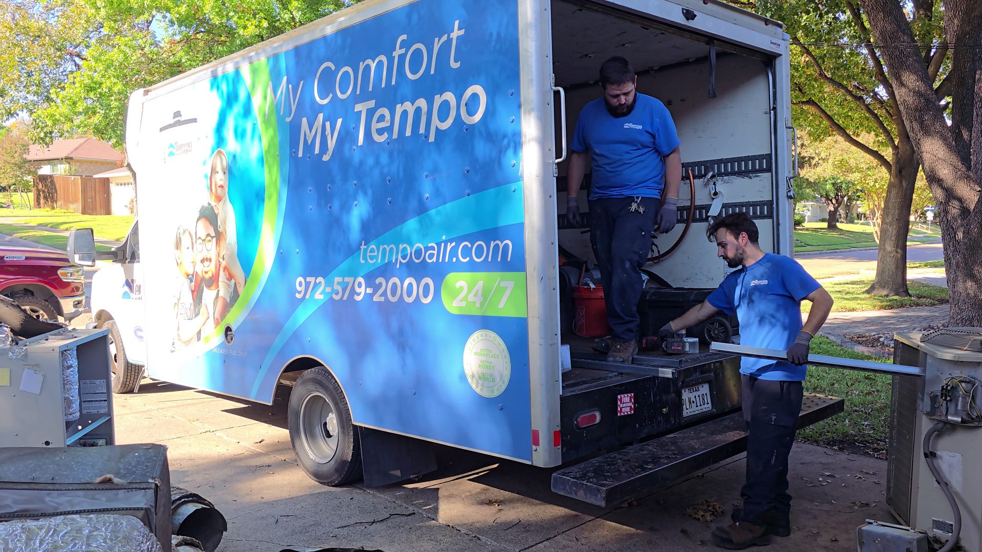 alt="Tempo Air Expert HVAC Technicians working with materials in the back side of a BoxTruck."